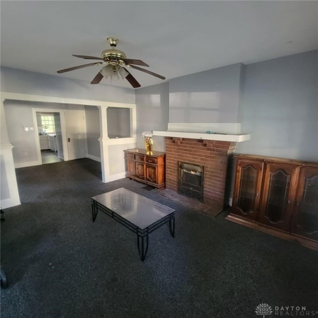 unfurnished living room featuring a fireplace, ceiling fan, and carpet flooring