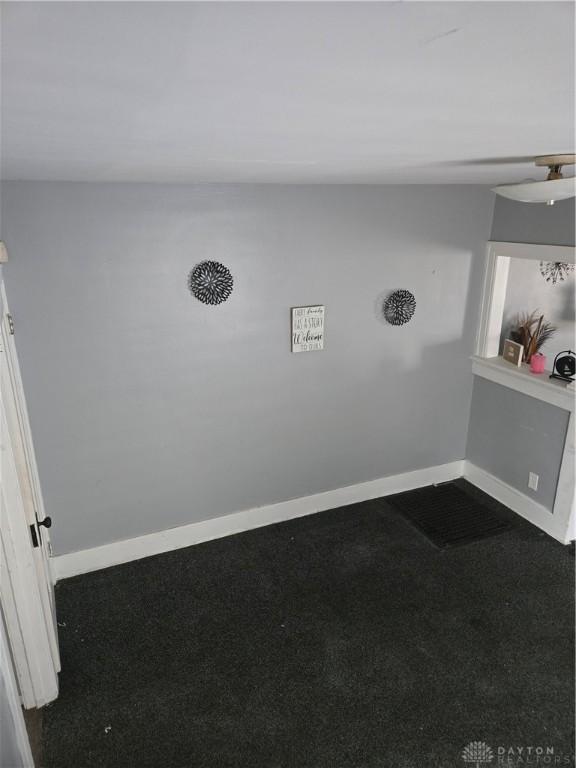 spare room with baseboards