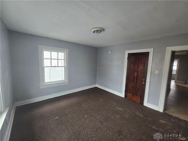 spare room featuring baseboards