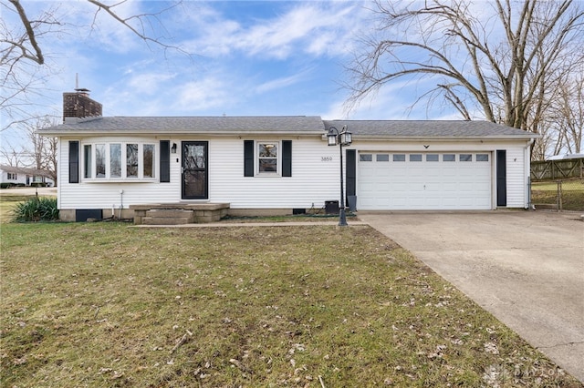 ranch-style house with a garage and a front lawn