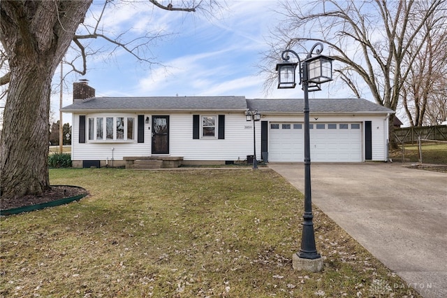 view of front of property featuring a garage and a front yard