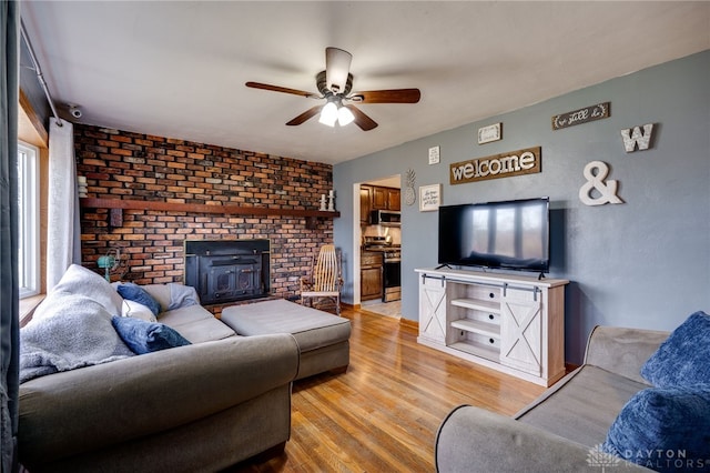 living room featuring light hardwood / wood-style floors and ceiling fan