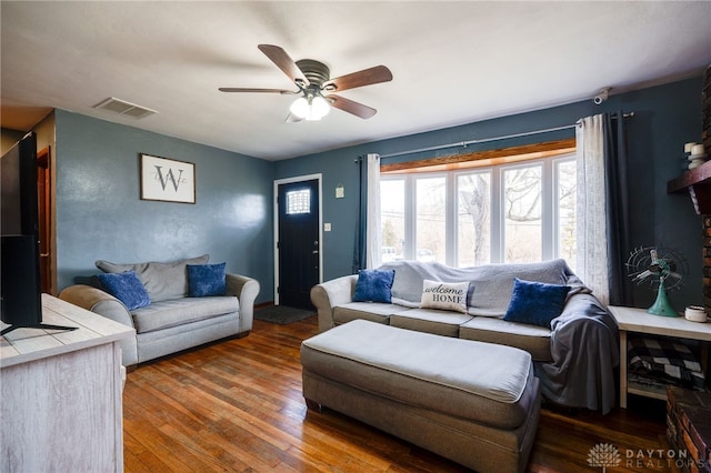 living room with dark hardwood / wood-style flooring and ceiling fan