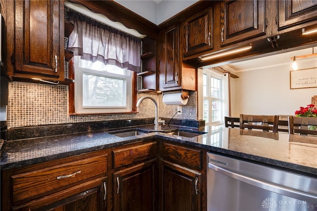 kitchen featuring sink, dark stone counters, decorative backsplash, stainless steel dishwasher, and dark brown cabinets