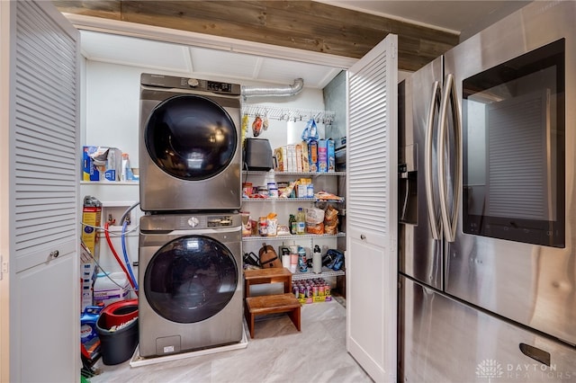 laundry room featuring stacked washer / dryer