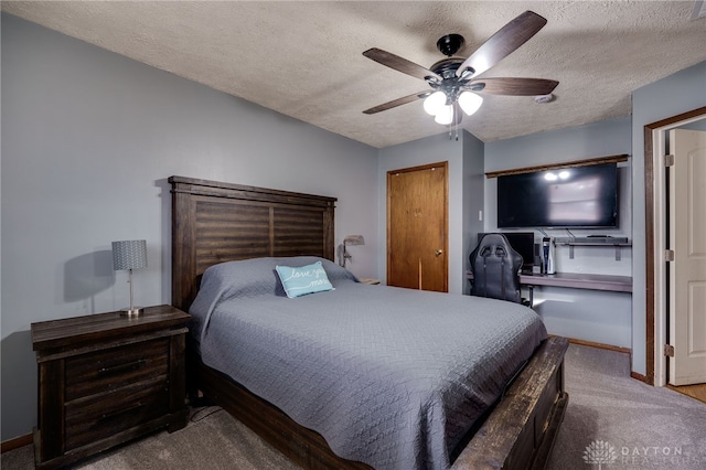 carpeted bedroom with ceiling fan and a textured ceiling