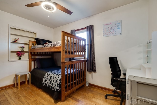 bedroom with light hardwood / wood-style floors and ceiling fan