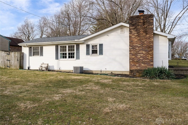 rear view of house with a yard and central air condition unit