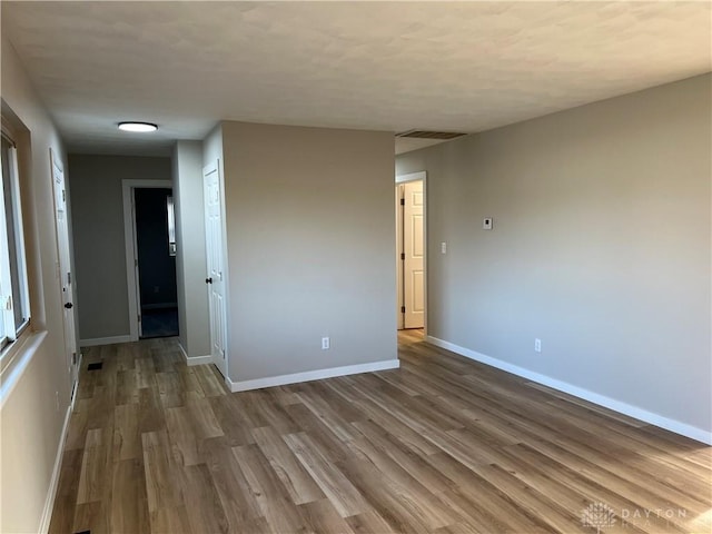 spare room with hardwood / wood-style floors