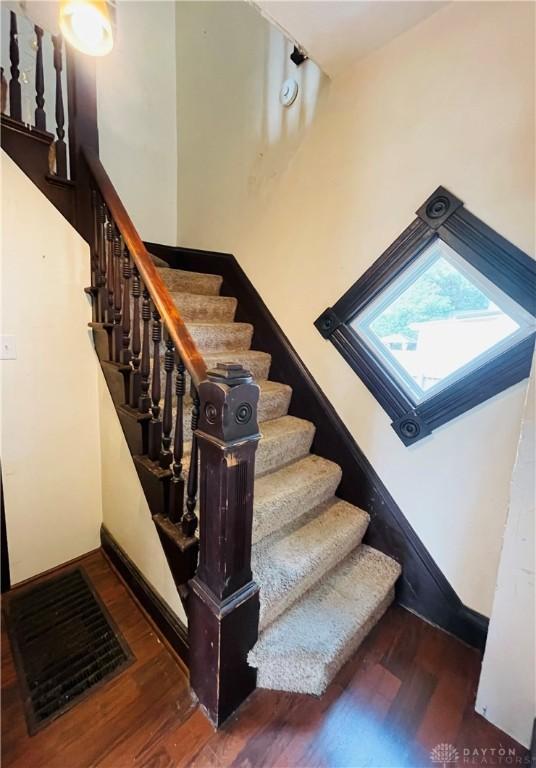 staircase with wood-type flooring