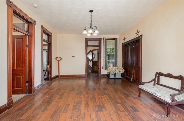 foyer entrance with a chandelier and dark hardwood / wood-style flooring