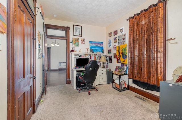 office featuring a textured ceiling and carpet