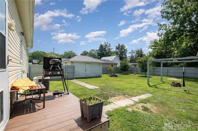 view of yard with a deck, a shed, and an outdoor fire pit