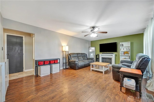 living room featuring hardwood / wood-style floors and ceiling fan