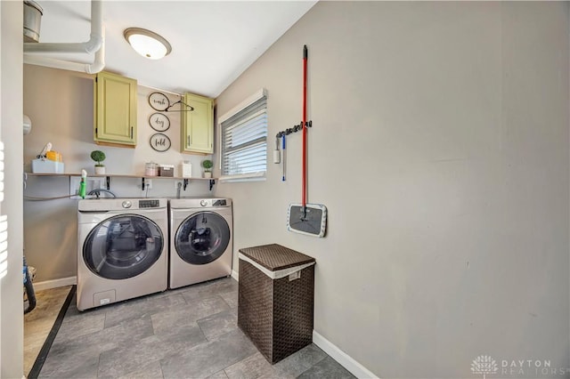 laundry room with cabinets and washing machine and clothes dryer