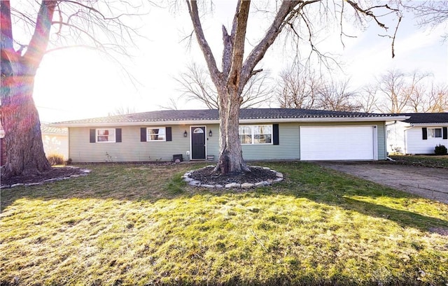 ranch-style home with a garage and a front yard