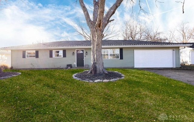 ranch-style house featuring a garage and a front yard