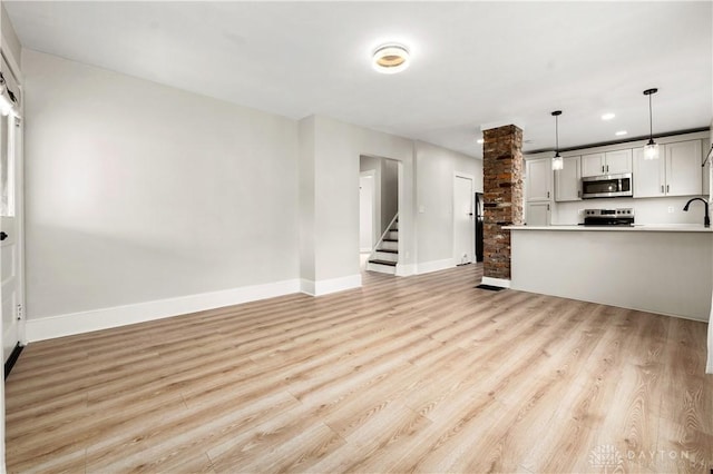 unfurnished living room featuring light hardwood / wood-style floors