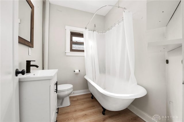 full bath featuring baseboards, vanity, toilet, and wood finished floors