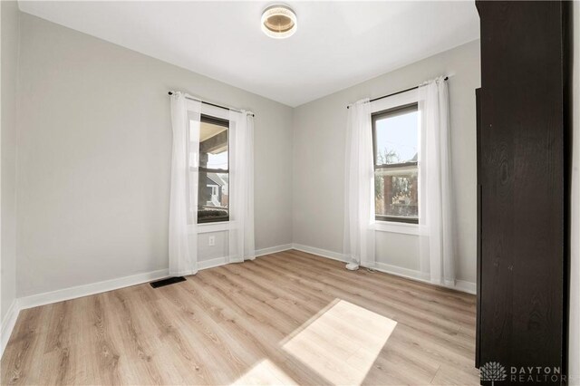 empty room with light hardwood / wood-style floors