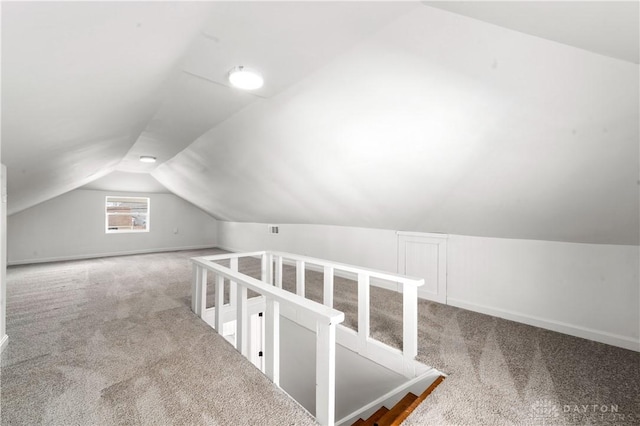 bonus room with carpet floors and vaulted ceiling