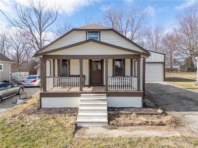 bungalow featuring a garage and a porch