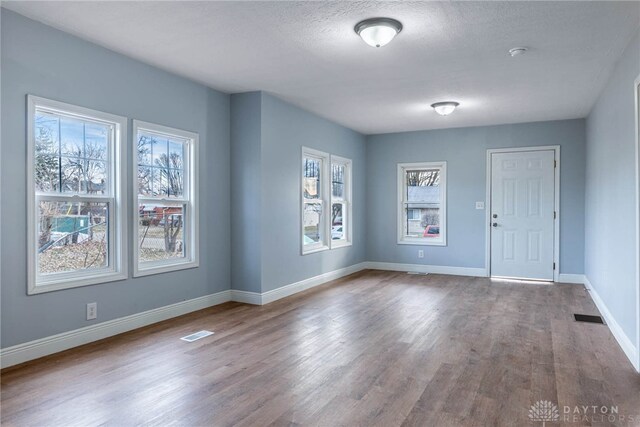 empty room featuring hardwood / wood-style floors and a textured ceiling