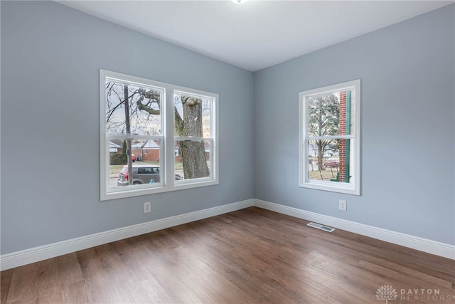 spare room with dark wood-type flooring