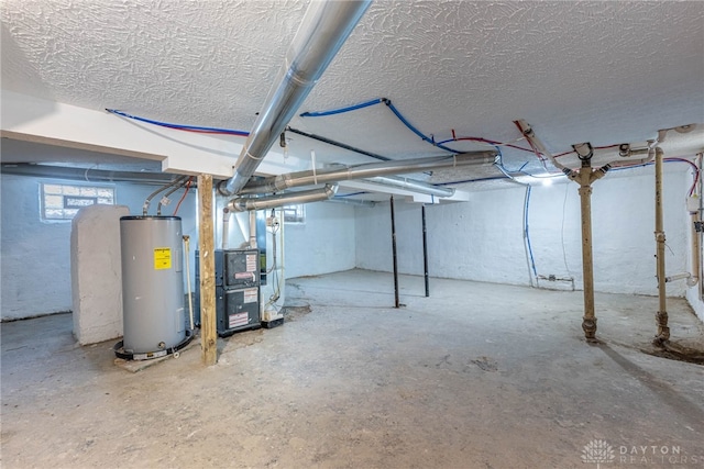 basement featuring heating unit, water heater, and a textured ceiling