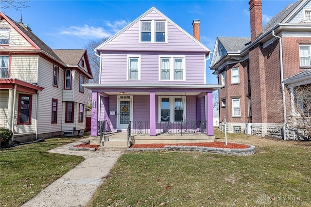 view of front of property with covered porch and a front yard