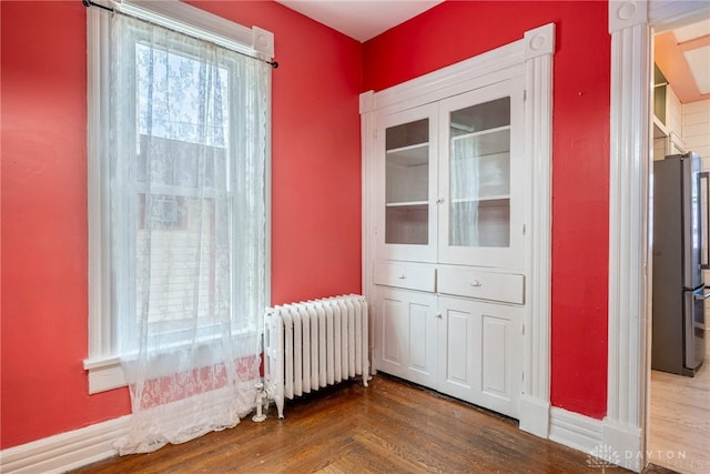 interior space with hardwood / wood-style flooring and radiator