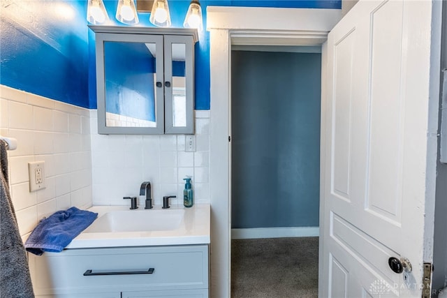 bathroom with vanity and tile walls