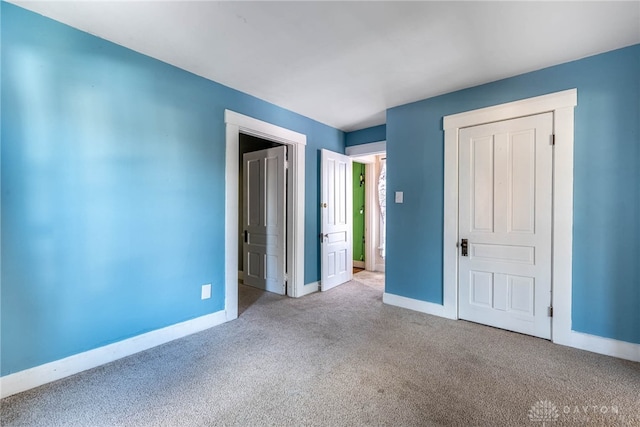 unfurnished bedroom featuring light carpet