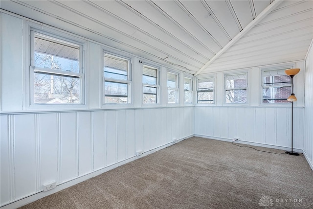 unfurnished sunroom featuring lofted ceiling and a healthy amount of sunlight