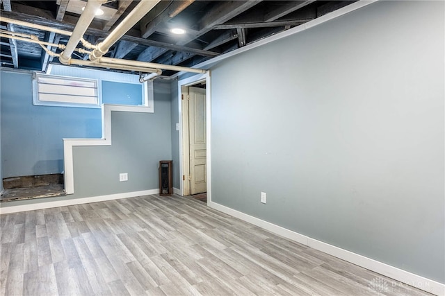 below grade area with wood finished floors and baseboards