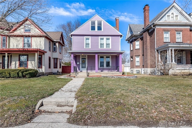 view of front of home featuring covered porch and a front yard