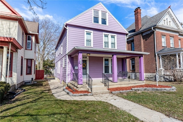 view of front of property with a porch and a front lawn