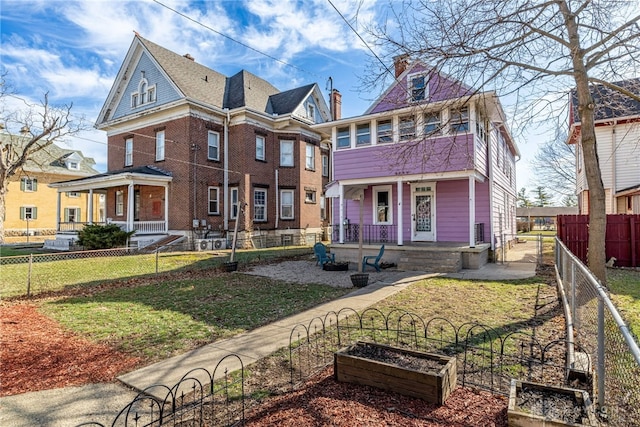 view of front of house featuring a front yard and covered porch