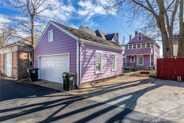 view of side of home with a garage and an outdoor structure