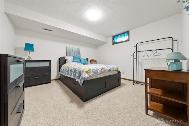 bedroom featuring light carpet