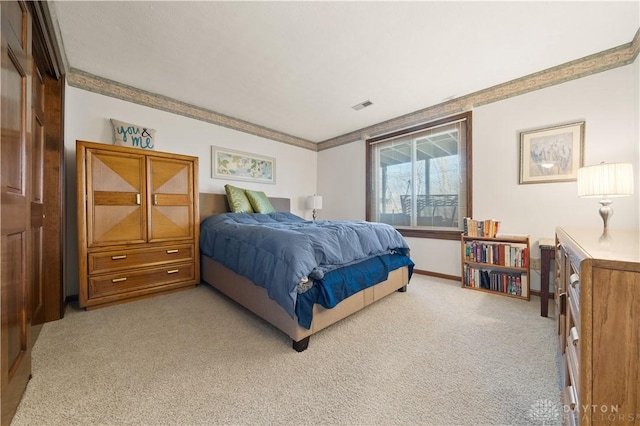 bedroom featuring crown molding and light colored carpet