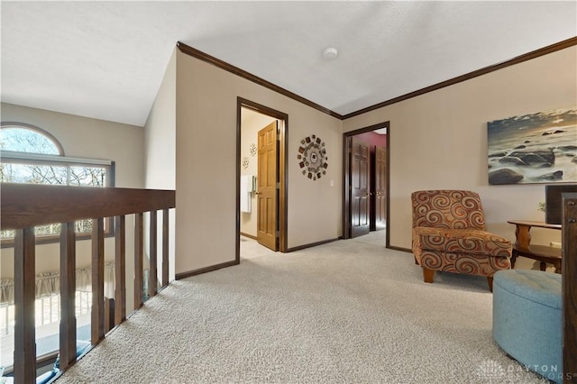 sitting room with ornamental molding, vaulted ceiling, and light carpet