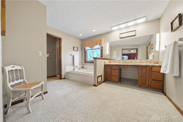 bathroom with a bathing tub and vanity