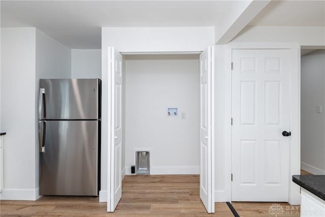 kitchen featuring light hardwood / wood-style flooring and stainless steel fridge