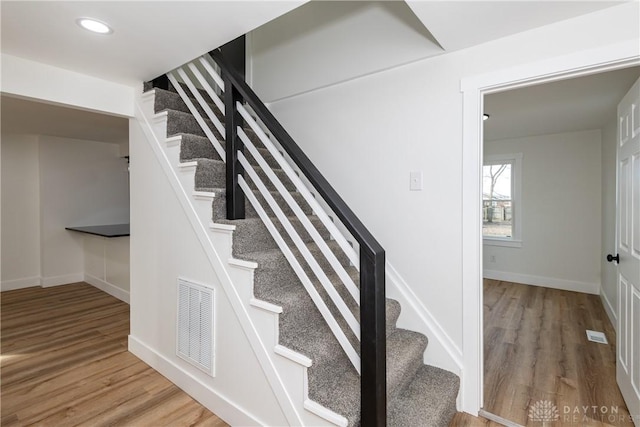 staircase with wood-type flooring