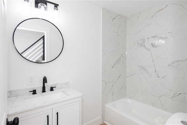 bathroom with vanity and tiled shower / bath combo