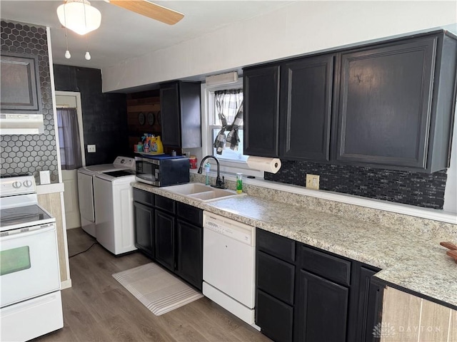 kitchen with dark hardwood / wood-style floors, separate washer and dryer, sink, ceiling fan, and white appliances