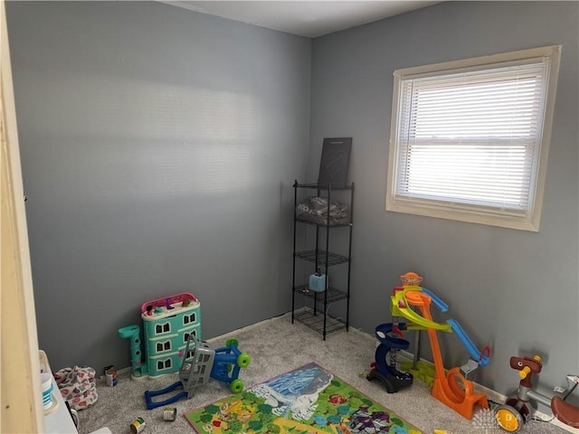 rec room featuring carpet and baseboards