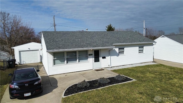 single story home with driveway, a shingled roof, a front lawn, and an outdoor structure