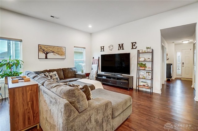 living room with dark hardwood / wood-style flooring